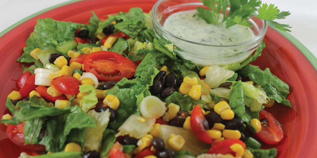 Southwest Salad with creamy cilantro dressing on side