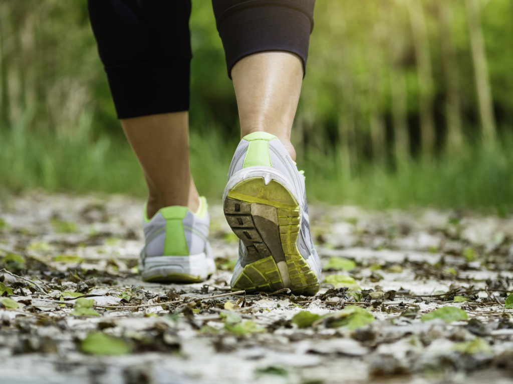 Woman Walking on Trail