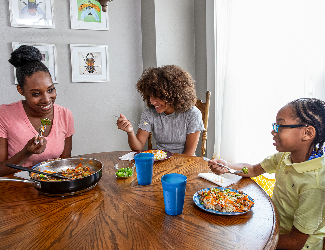 Children eating healthy food with their mother