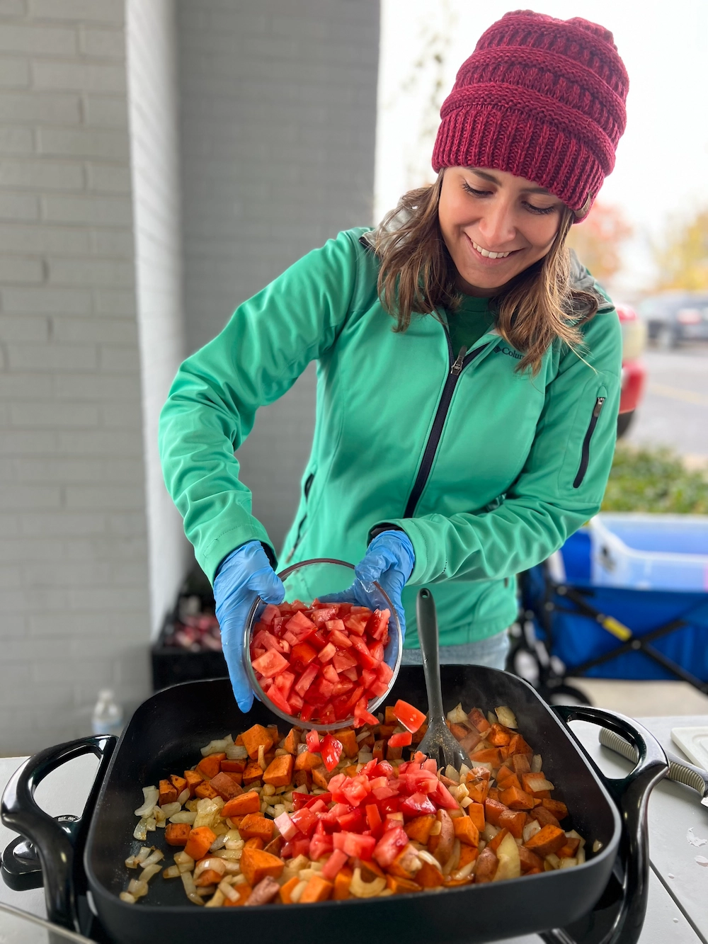 Woman giving cooking demo at farmers market.