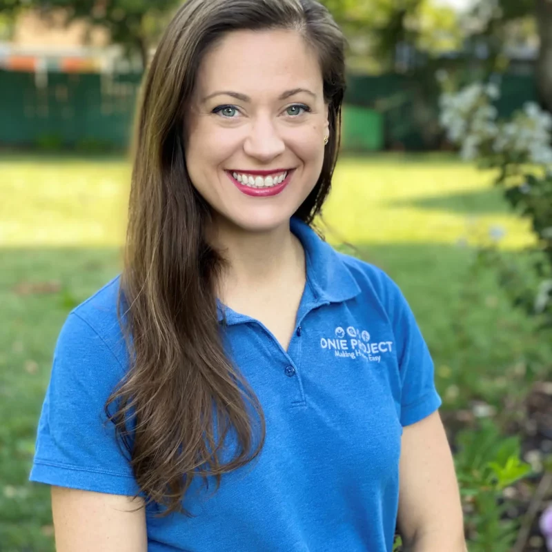 Headshot of Meredith Scott-Kaliki wearing an ONIE Project polo with an outdoor background.