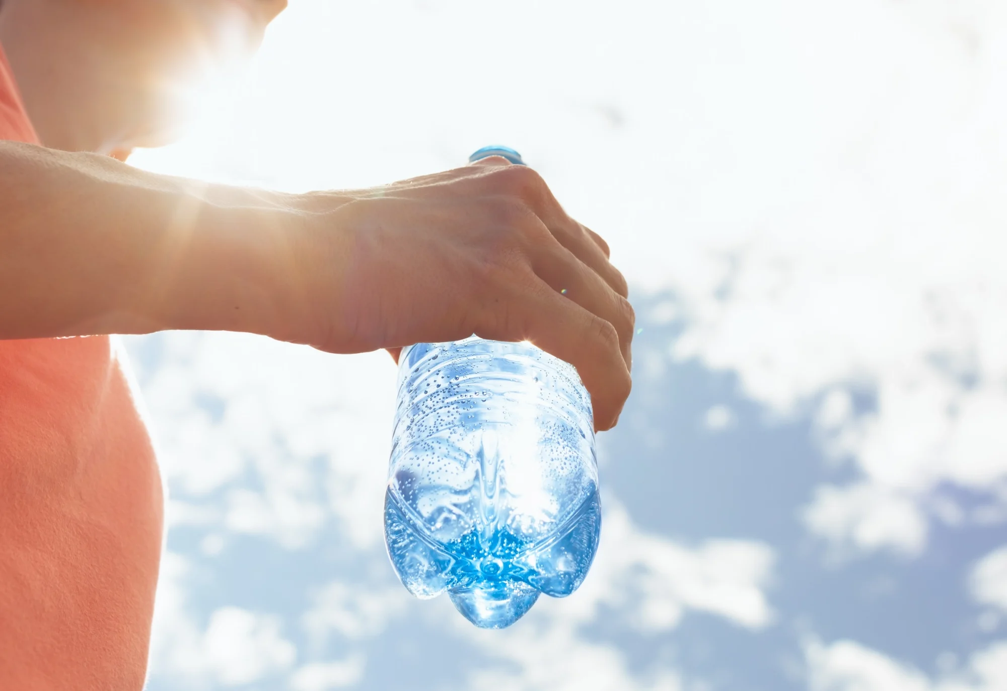 Hand holding water bottle